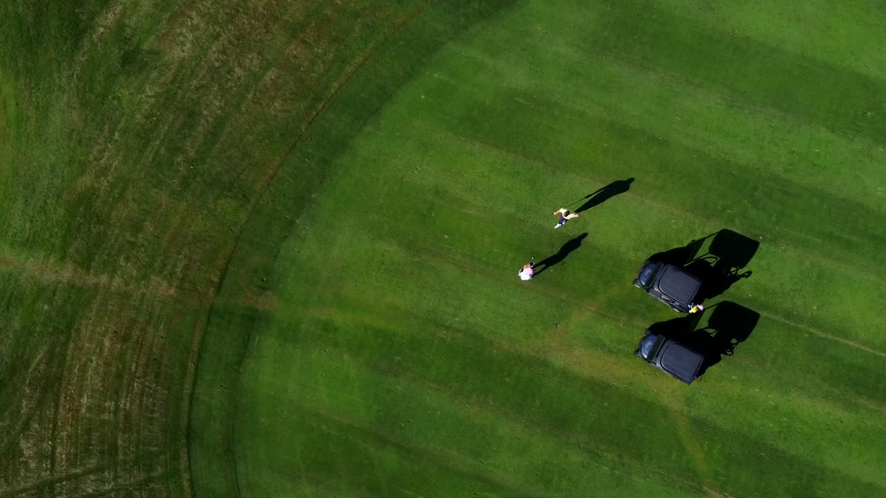 Golf course with people and golf carts