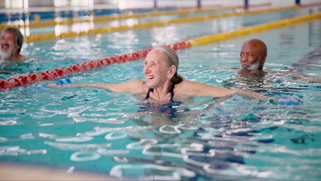 senior citizens enjoying water exercise in a swimming pool