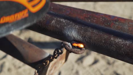 a welder wearing helmet for protection while welding an old rusted pipe - close up