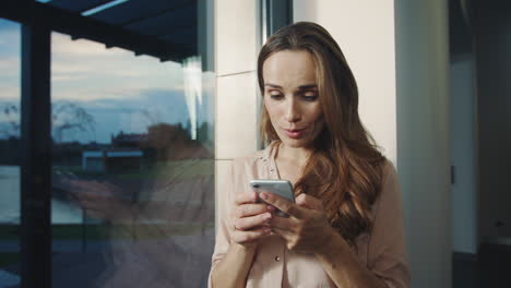 smiling woman chatting on cellphone. portrait of happy woman sending message.