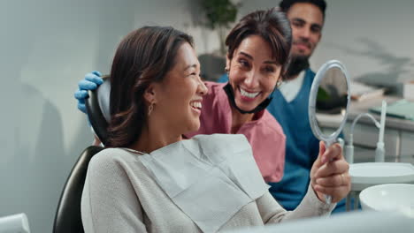 happy woman smiling at the dentist after a dental procedure