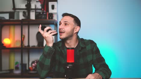 young man holding phone near his face, speaking to an ai-powered language assistant. concept of artificial intelligence, smart technology, and digital communication.