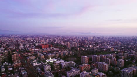 Aerial-establishing-shot-of-downtown-Ñuñoa,-Chile-at-sunset