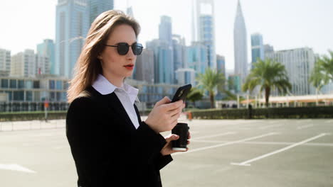 elegant businesswoman with phone outdoors