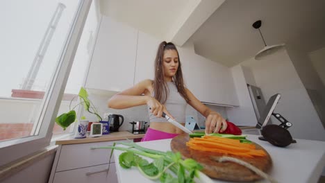 young woman chopping vegetables in a modern kitchen