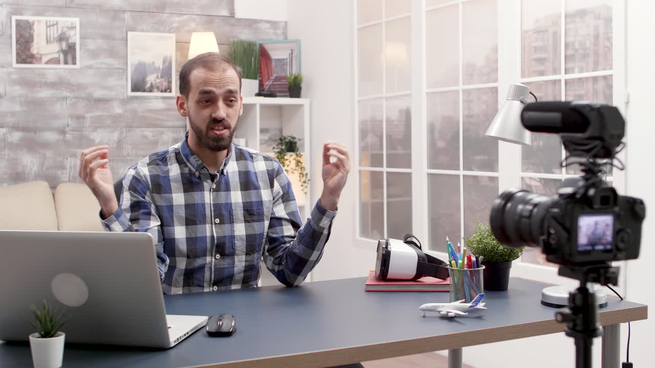 Man Vlogging with Camera and Laptop