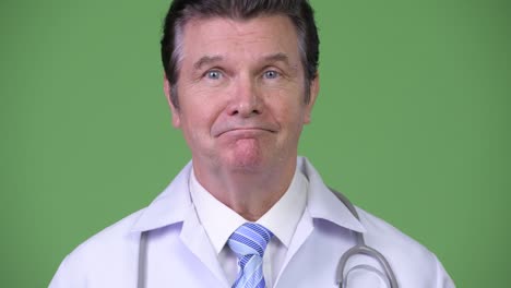 senior handsome man doctor nodding head no