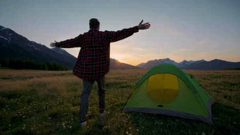 man enjoying sunset during a camping adventure in the mountains