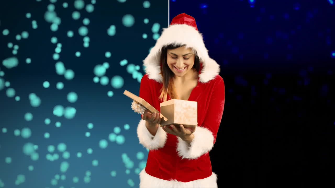 Opening gift box, woman in Santa outfit over falling snowflakes animation