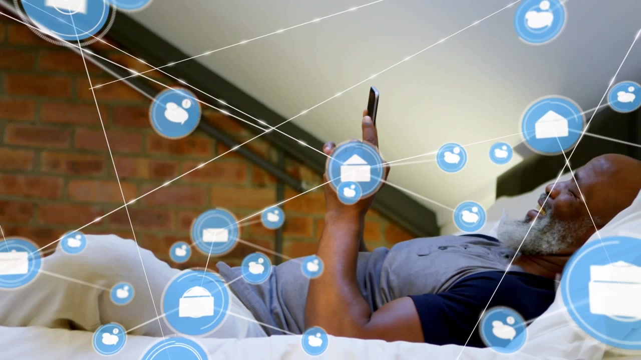 Animation of network of connections with icons over businessman using smartphone