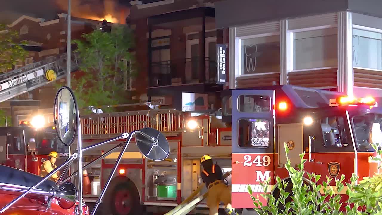 Fire engine and burning private home building in Canada, static view