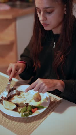 Young woman eating dinner
