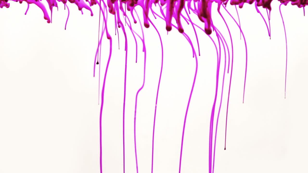 Colorful chemical liquids mix and swirl in water, forming smooth abstract patterns and organic shapes