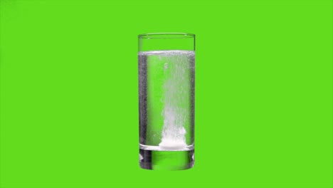 the tablet dissolves in water on an green screen