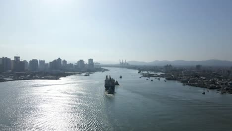 Cargo-Ship-Sailing-On-The-Ocean-Near-Santa-Catarina,-Southern-Brazil---drone-shot