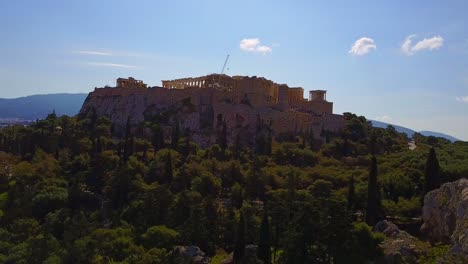 acropolis ruins with a low pull out drone shot with tilt up, greece