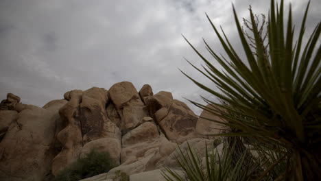 Timelapse-of-cloudy-sky-in-Joshua-Tree-National-Park-behind-large-boulders-and-rocks-in-California