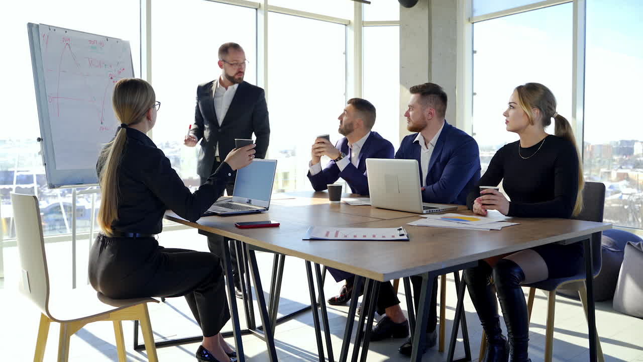 Happy business team discussing together at office meeting with laptop. Brainstorming at the office.