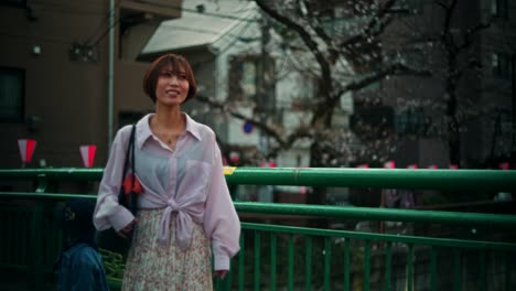 woman walking in a city with cherry blossoms