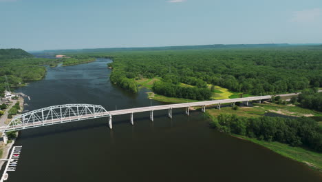 panoramic aerial of the wabasha–nelson bridge with dense forest trees in wabasha, minnesota, usa