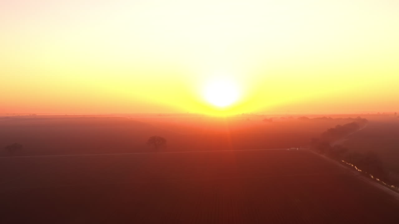 California sunrise, hazy atmospheric fields and water canal