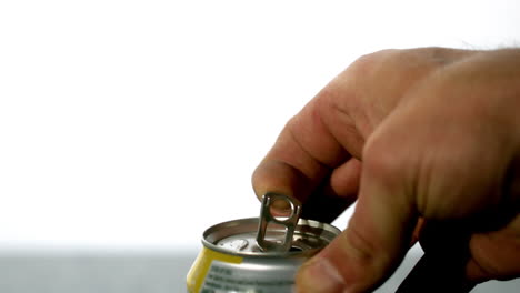 hand opening a soda can