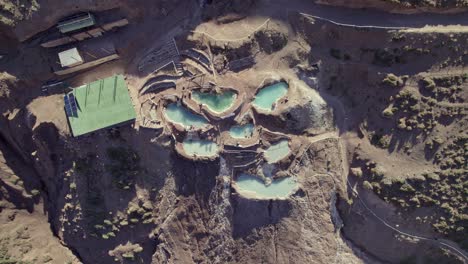 view from above of valle de colina hot spring pools in the andes mountains, cajon del maipo, chile