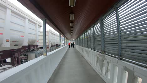 pov while walking on the nuevo progreso international bridge that crosses the rio grande river between mexico and texas