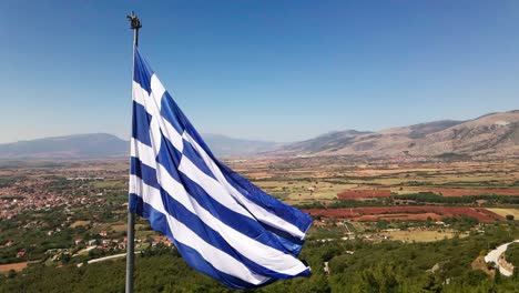 Clip-Aéreo-De-Drones-4k-De-Una-Bandera-Ondeando-Sobre-El-Monte-Korilovos-En-El-área-Del-Drama-En-El-Norte-De-Grecia