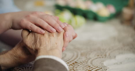 woman comforting wrinkled old hand 1