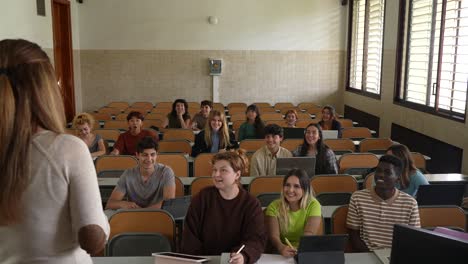 Faceless woman teaching students at class