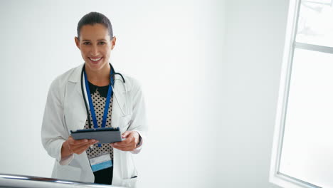 Portrait-Of-Female-Doctor-With-Digital-Tablet-Checking-Patient-Notes-On-Stairs-In-Hospital