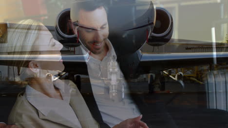 at airport, business professionals discussing animation reflected on airplane glass
