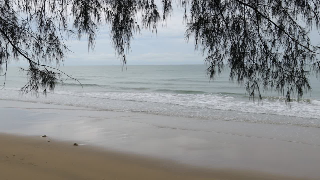 Rayong beach while rain and strong waves in the rainy season. Cloudy rainy weather with strong wind