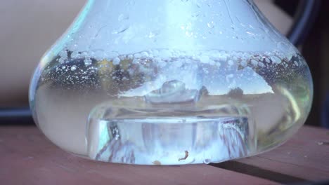 air bubbles in transparent water glass flask for smoking hookah