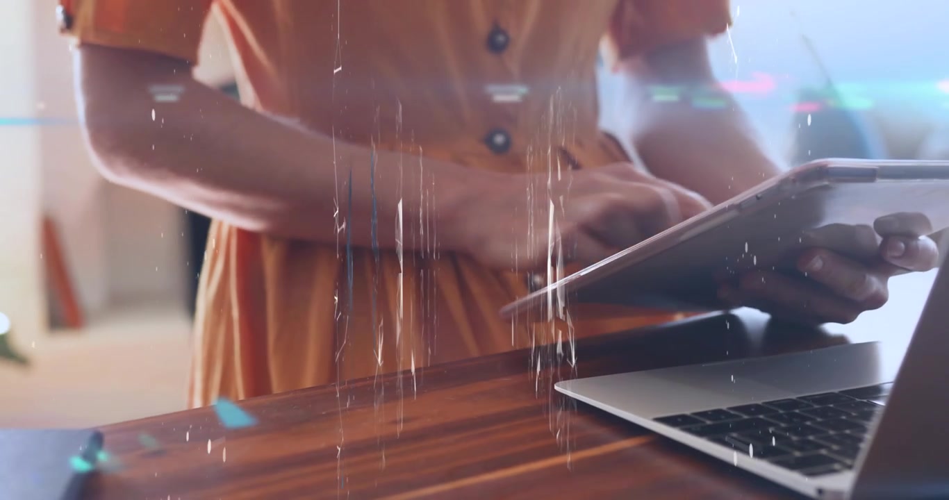 Woman Working on Laptop and Tablet in Modern Workspace