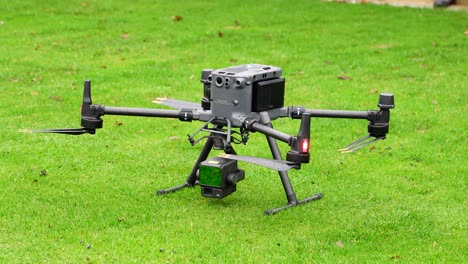 large industrial drone with lidar system camera payload on green grass