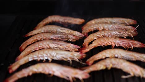 rows of shrimp cooking on a hot grill