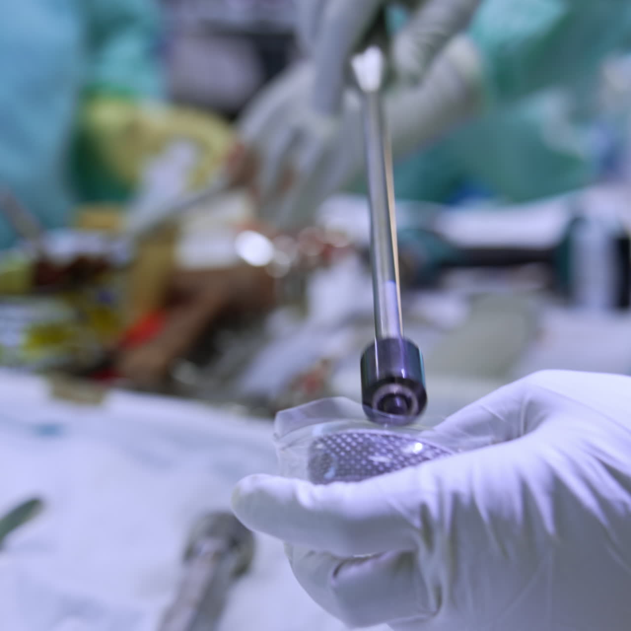 Gloved hands of a medic hold and assemble the orthopedic tool. Close up. Trauma surgery concept
