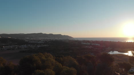 drone flying trough trees with breathtaking mountain and costal view