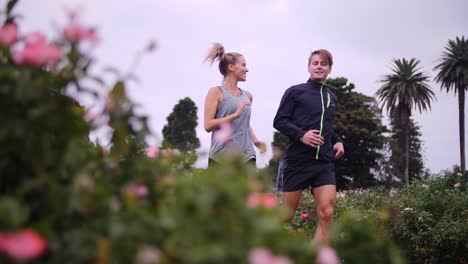 couple jogging through rose gardens on a cloud day