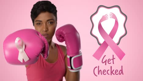 animation of pink ribbon logo with breast cancer text over woman wearing boxing gloves