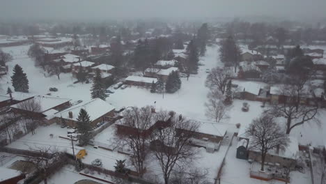 Descending-aerial-view-into-a-snowy-suburban-neighborhood