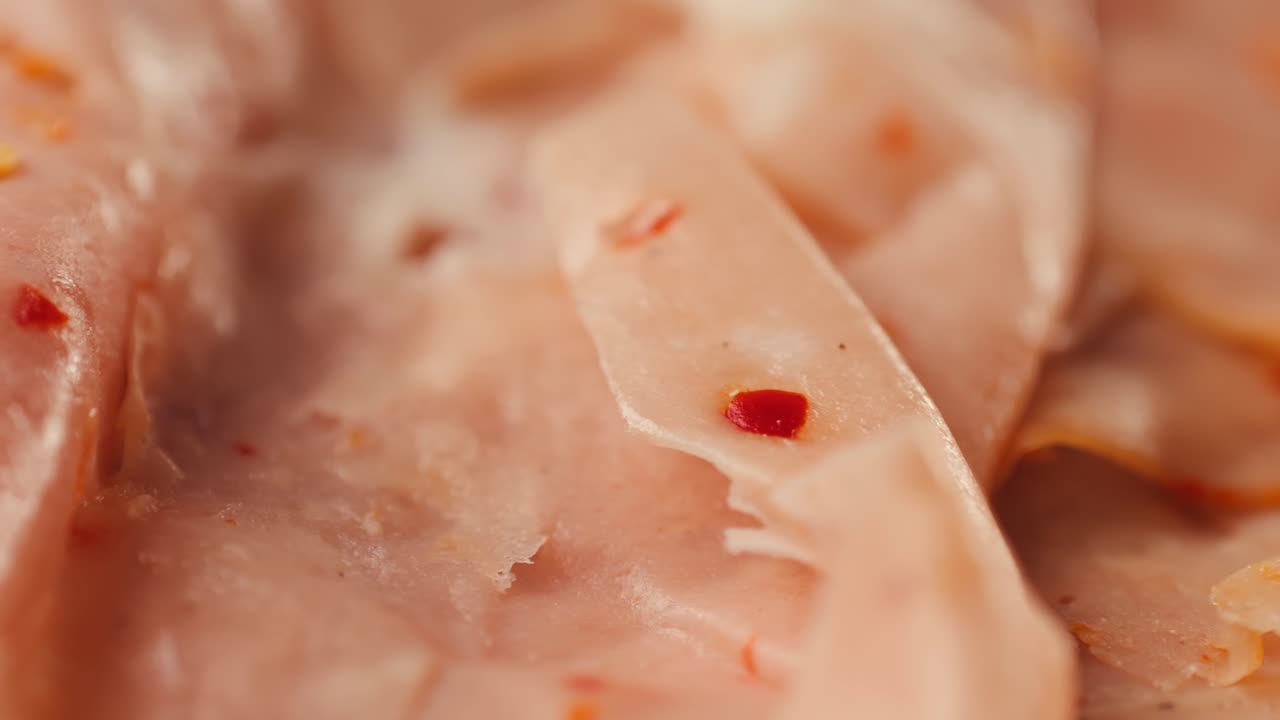Ham italian mordatella, man Slices Of Traditional Italian antipasti mortadella sausage on a wooden cutting board, close up macro of chicken or turkey jamon, fat breakfast dish.