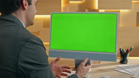 businessman using a computer with a green screen