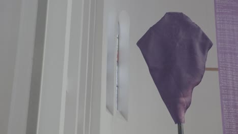 a veiled cross in a church, a banner hanging from the ceiling in the background, holy week, good friday