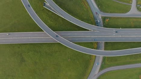 an aerial view a country highway with a bridge and overpasses on which cars and trucks travel