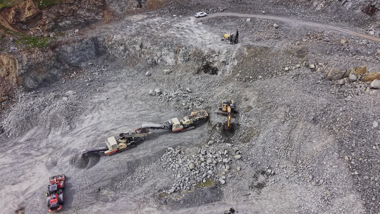 Aerial View of Heavy Machinery Working in a Rock Quarry