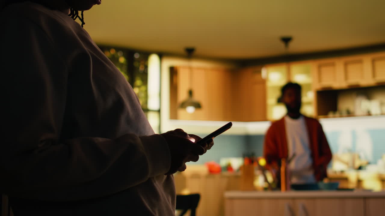 Adult black woman enjoying cozy moment at home and browsing apps
