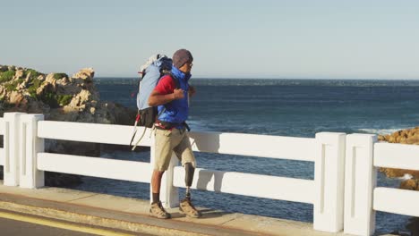 sporty mixed race man with prosthetic leg hiking